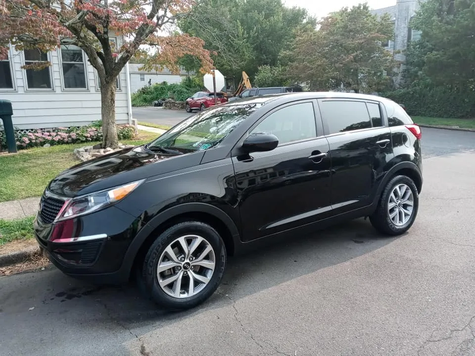 A freshly detailed black SUV with a deep mirror shine