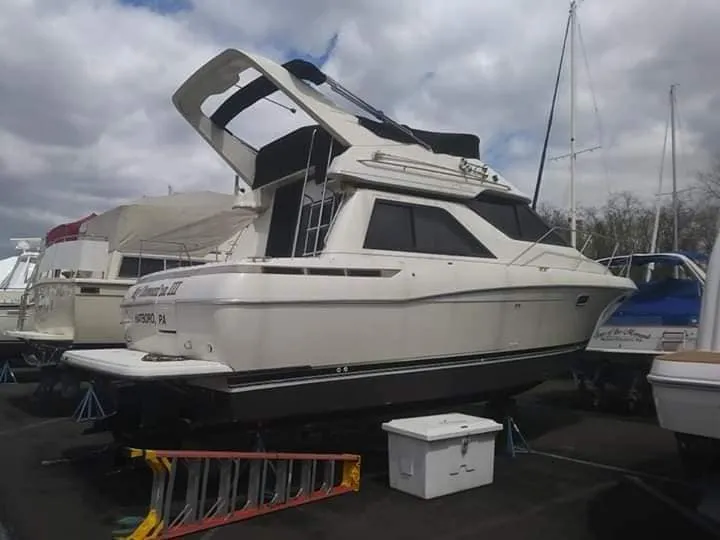 White cabin cruiser boat cleaned at the marina