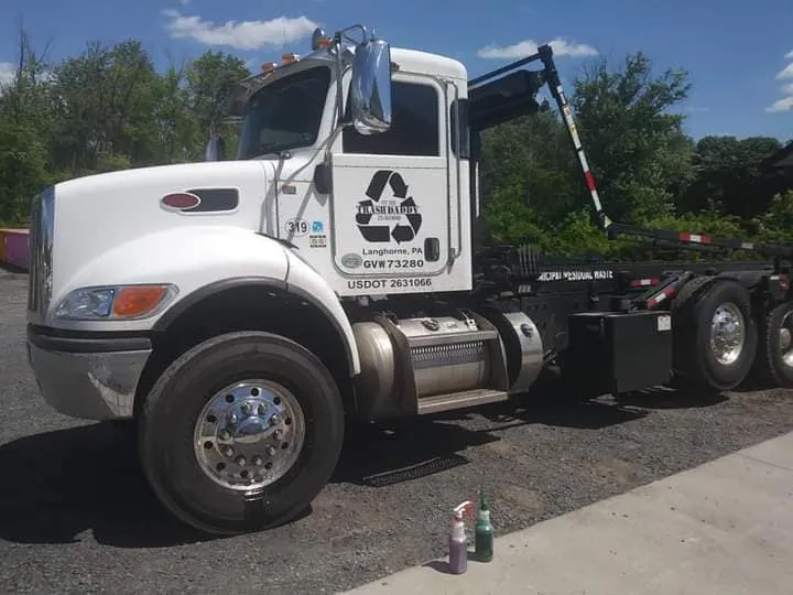 White Peterbilt commercial roll-off truck washed