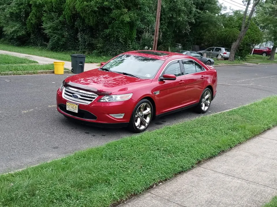 A deep-red sedan detailed to a high gloss by Evans' Detailing