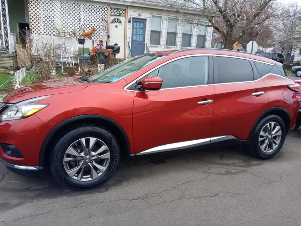 Red Nissan Murano SUV washed and waxed